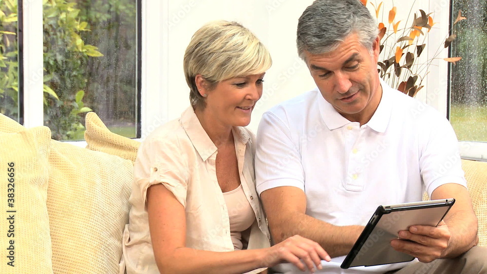 Middle Aged Couple Happy with Their Financial Planning Middle Aged Couple Happy with Their Financial Planning