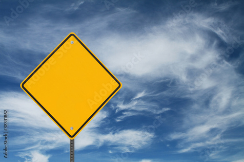 Blank Warning Sign on Swirling Clouds