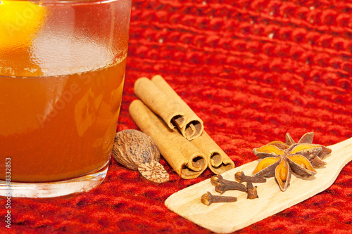 Bild auf Leinwand Glass of mulled wine on woven