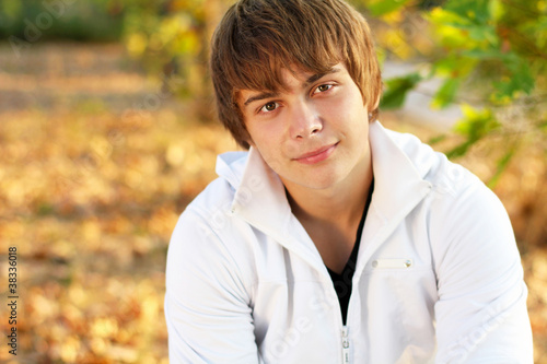 Portrait of attractive young man outdoors, looking at camera