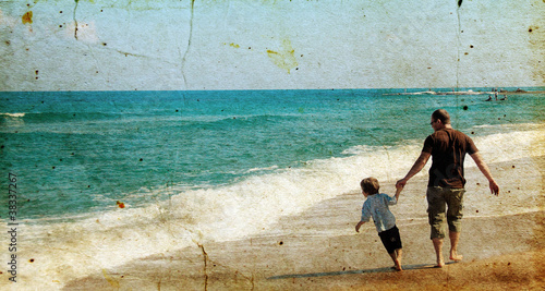 father and son playing together on the beach. Photo in old image
