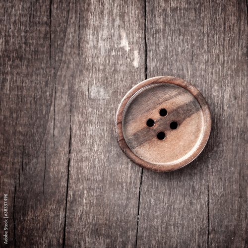 button on a wooden table
