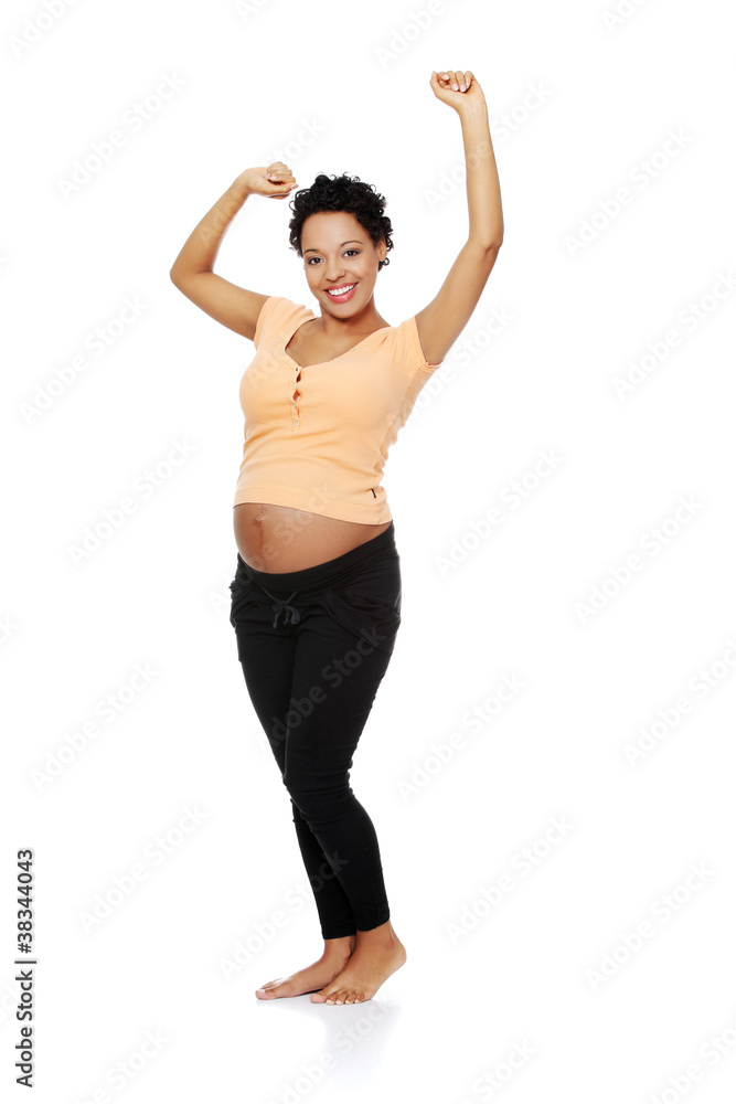 Pregnant woman stretching her body. Pregnant woman stretching her body.