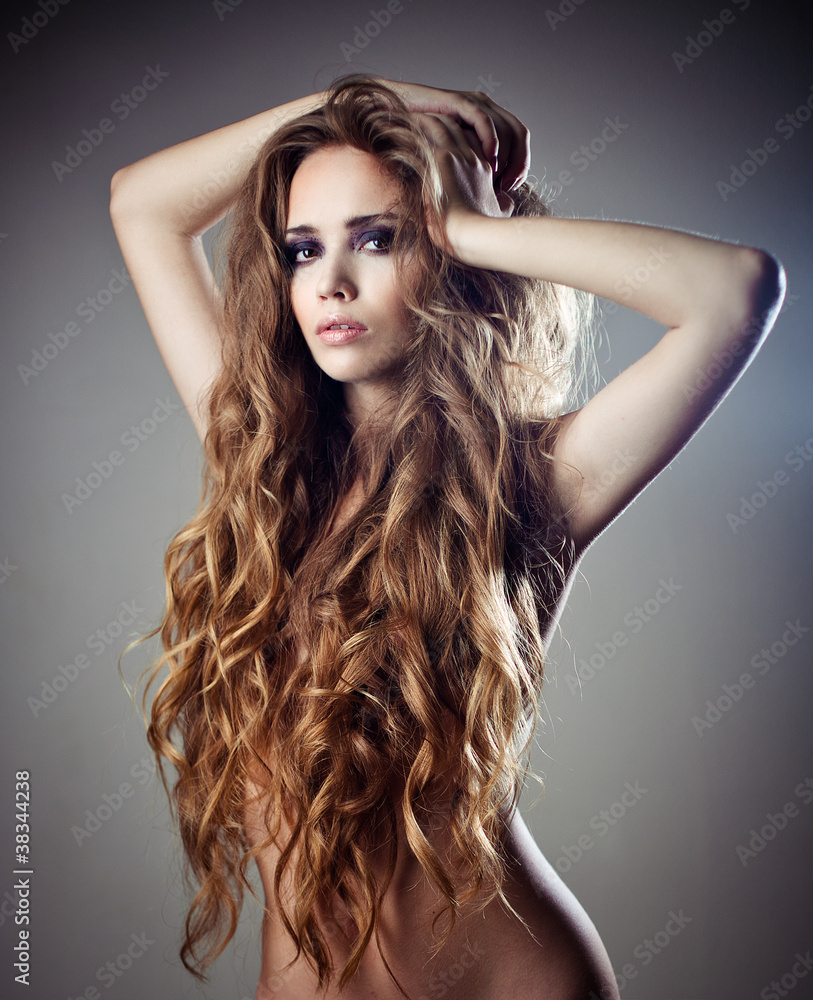 Beautiful sexy woman with long curly hair Stock Photo | Adobe Stock