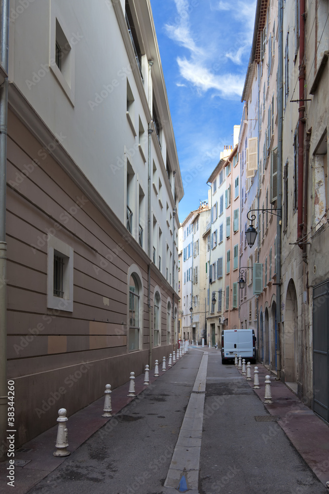Pastel coloured buildings along narrow street in Toulon