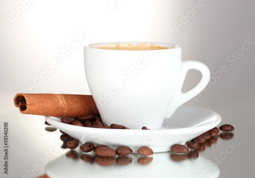cup of coffee, cinnamon and coffee beans isolated on white