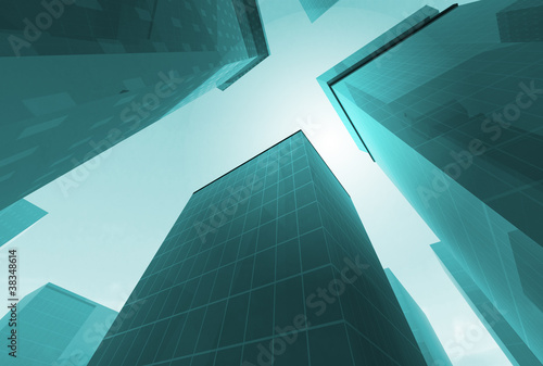 Abstract angle of green glass skyscrapers with bright sun