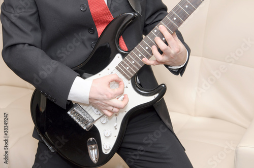 Businessman playing guitar photo