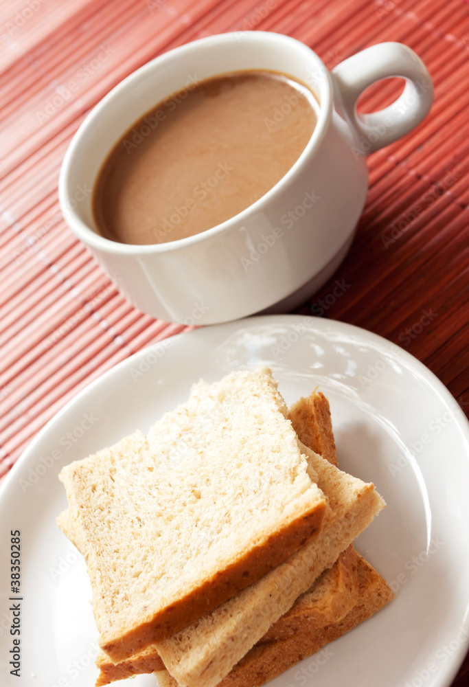 A cup of white coffee and bread A cup of white coffee and bread