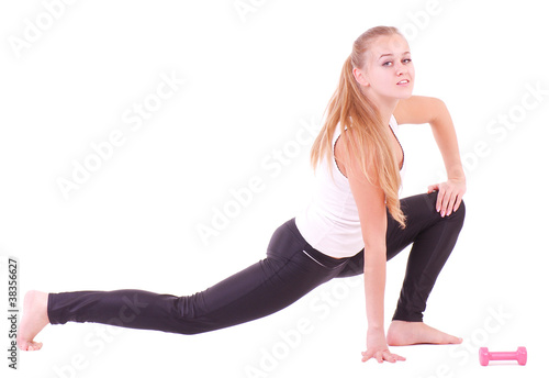 Beautiful smiling girl with free weights in gym