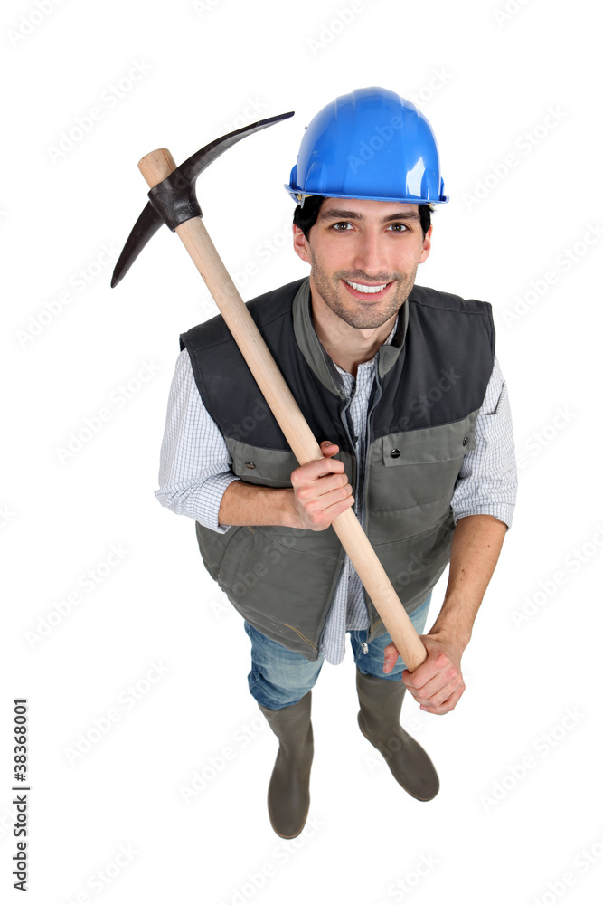 A manual worker with a pickaxe.
