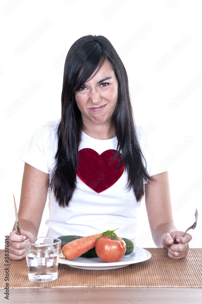 unhappy woman keeping a diet and eating vegetables