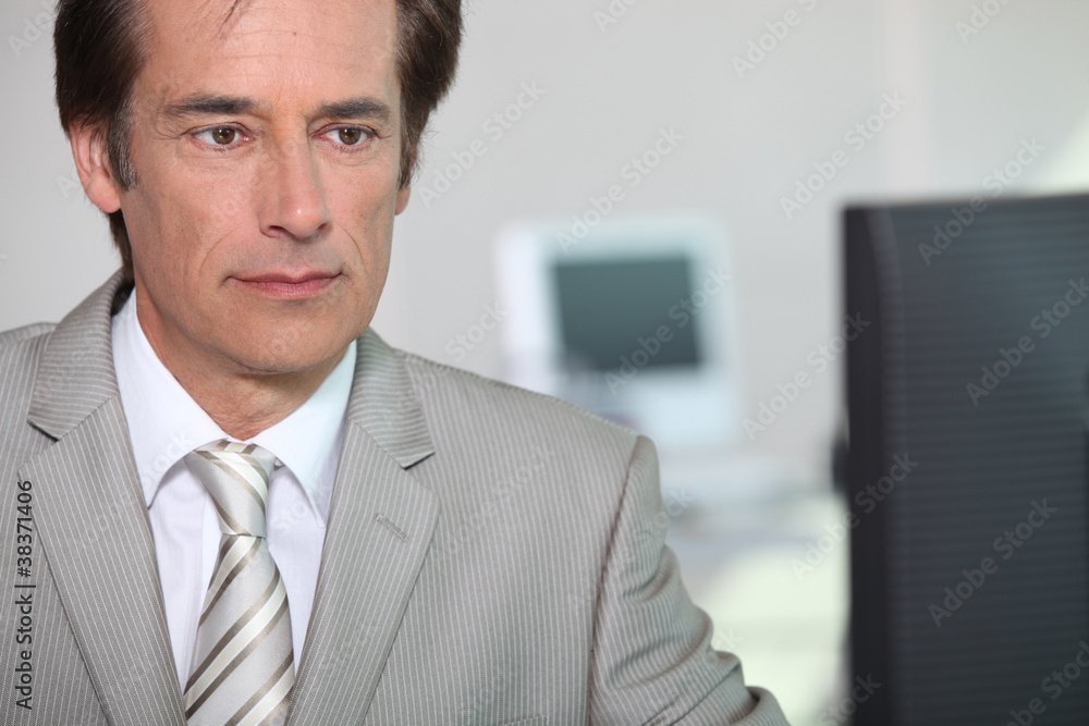 businessman looking at computer businessman looking at computer