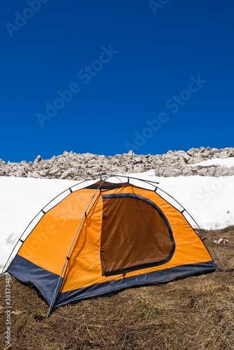 orange touristic tent on a snow