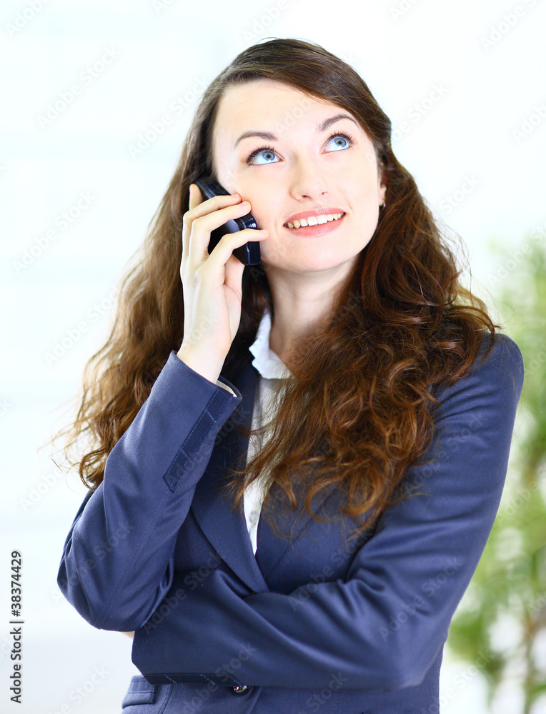 Portrait of a pretty young business lady talking on Portrait of a pretty young business lady talking on