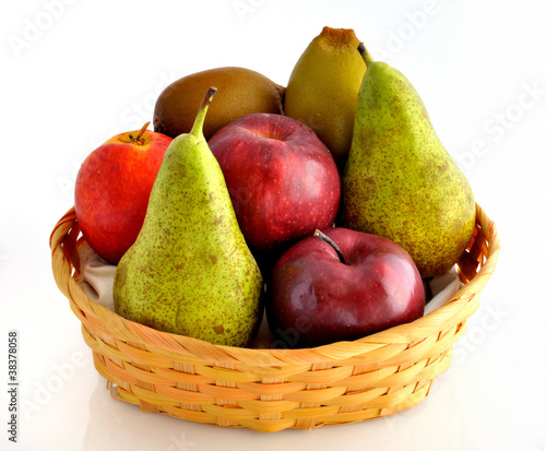 apples, kiwi, pears and an italian peach in wicker basket