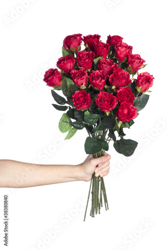 Hand holding bouquet of red roses