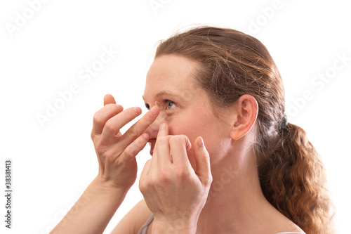 Young woman Inserting a contact lens