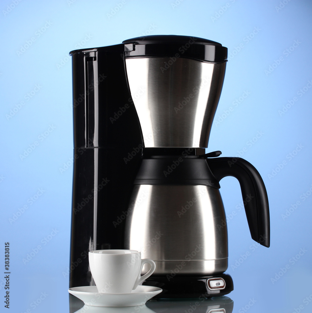 Coffee maker with white cup on blue background Coffee maker with white cup on blue background