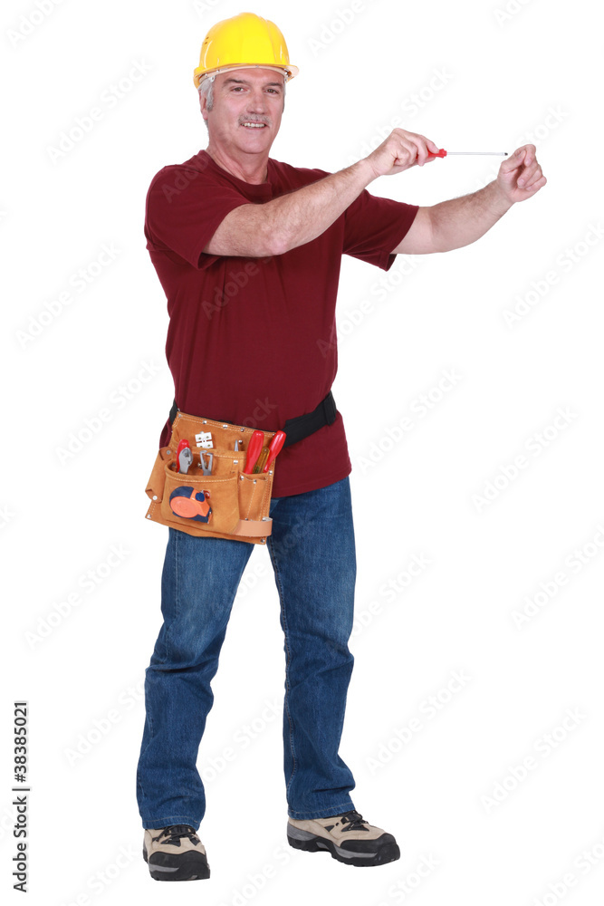 Construction worker using a screwdriver in empty copyspace Construction worker using a screwdriver in empty copyspace