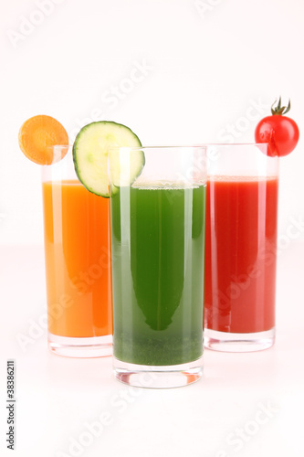 glasses of vegetables juice on white