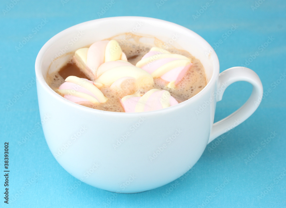 Cup of cappucino with marshmallows on blue background Cup of cappucino with marshmallows on blue background