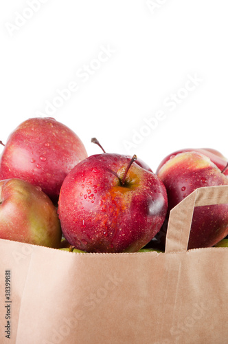Shopping paper bag with red apples, white background