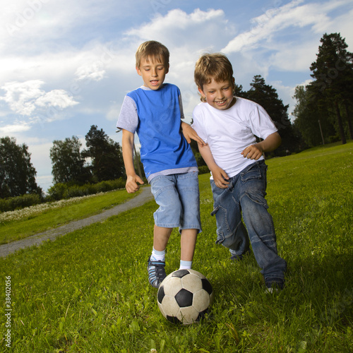 two happy boy play in soccer