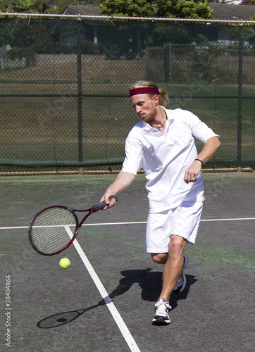 Male tennis player makes a forehand swing © sonofpioneer