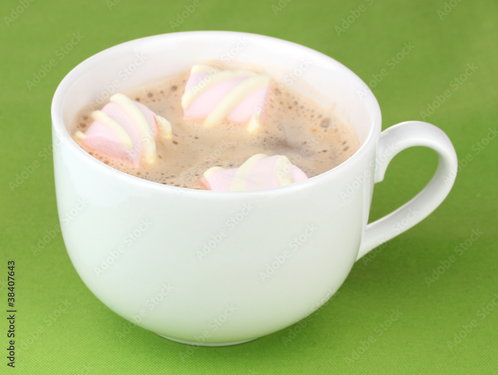 Cup of cappucino with marshmallows on green background Cup of cappucino with marshmallows on green background