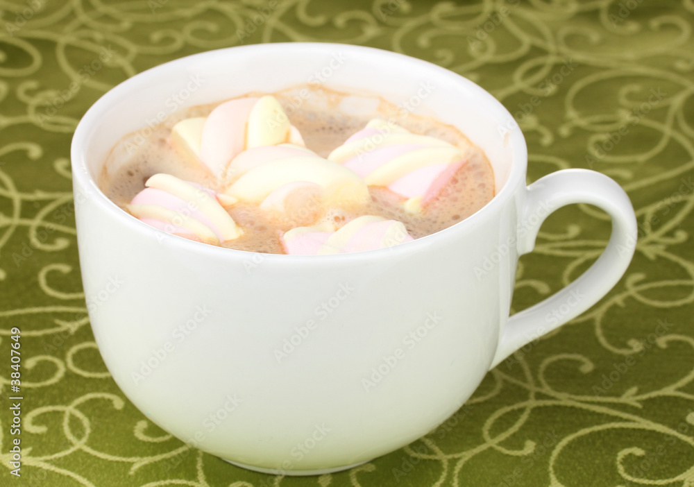 Cup of cappucino with marshmallows on green tablecloth Cup of cappucino with marshmallows on green tablecloth