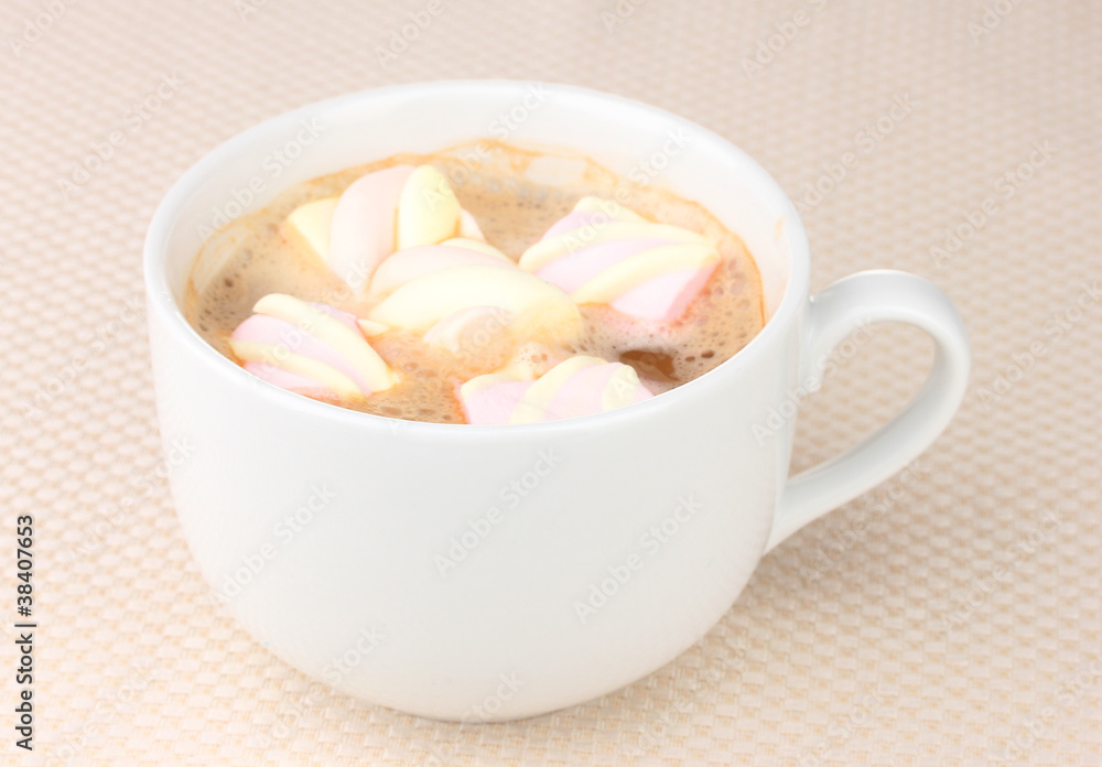 Cup of cappucino with marshmallows on beige background Cup of cappucino with marshmallows on beige background