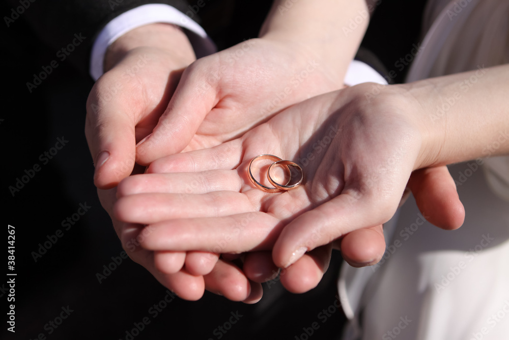 hands of the newlyweds with wedding rings