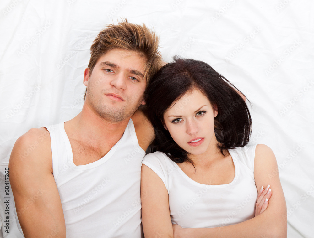 young upset couple in bed