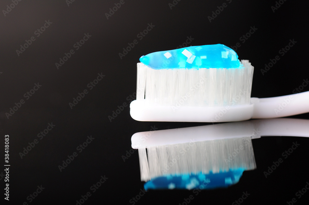 toothbrush with blue toothpaste on it toothbrush with blue toothpaste on it