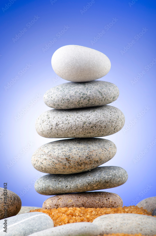 Fototapeta premium Balanced pebbles with colour background