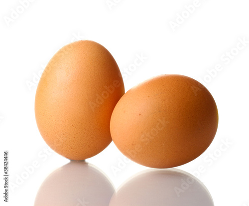 two brown eggs isolated on white