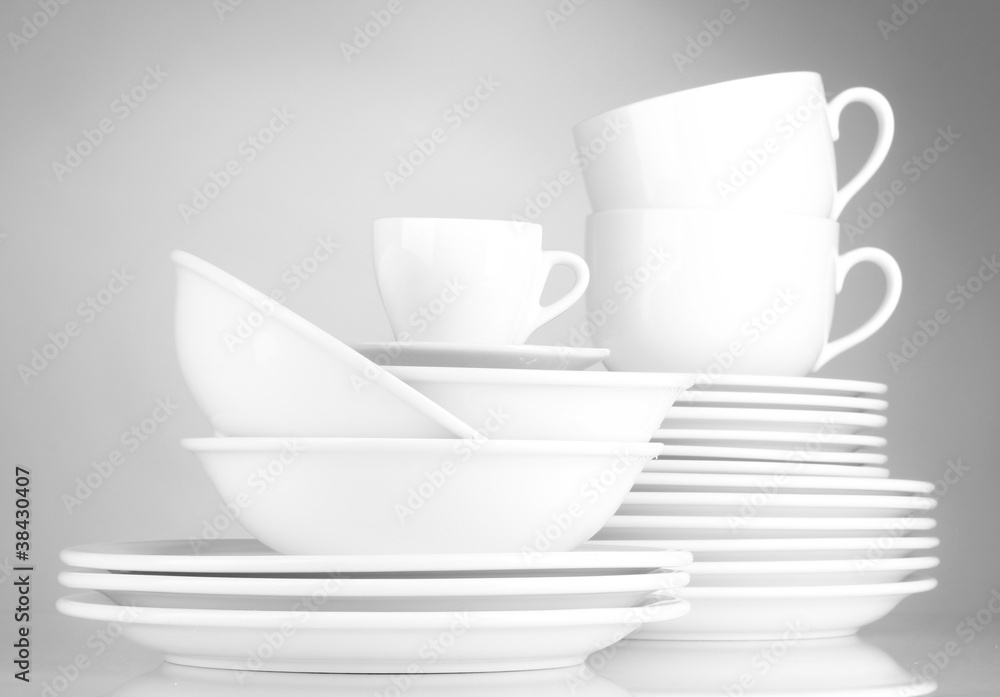 empty bowls, plates and cups on gray background empty bowls, plates and cups on gray background