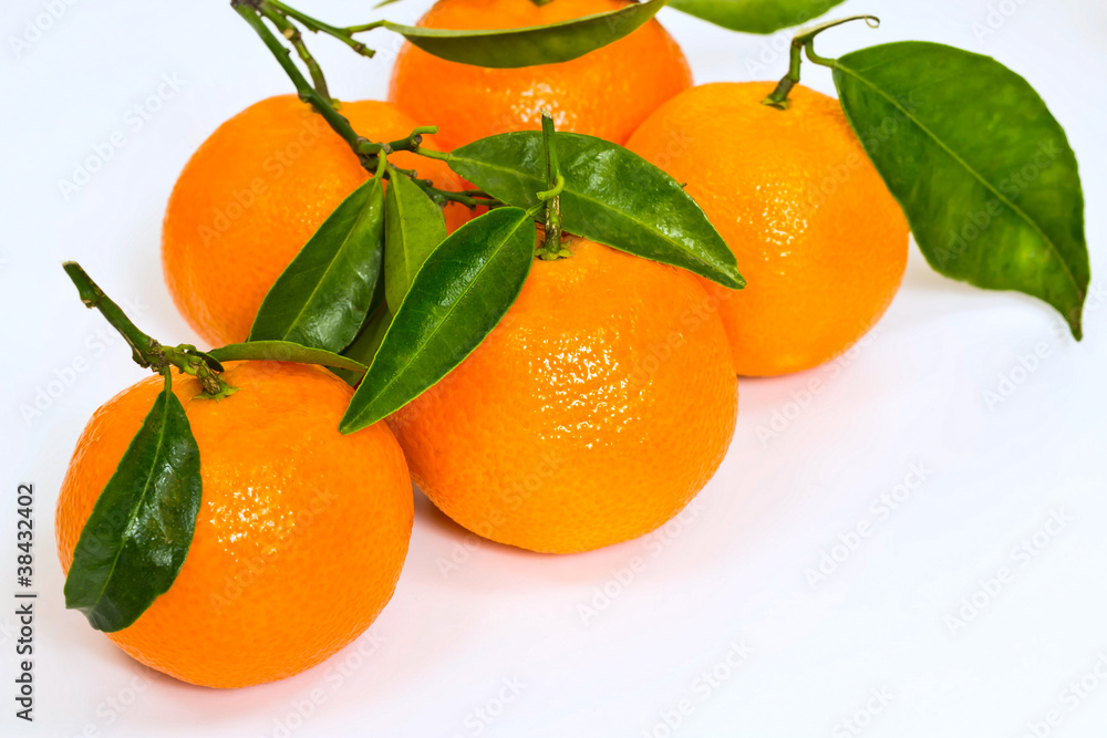 a few fresh sweet mandarin with green leaves a few fresh sweet mandarin with green leaves