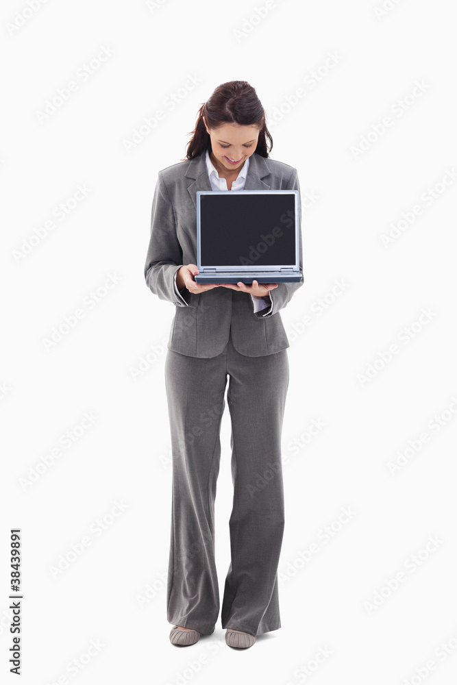 Businesswoman looking and showing a laptop screen Businesswoman looking and showing a laptop screen