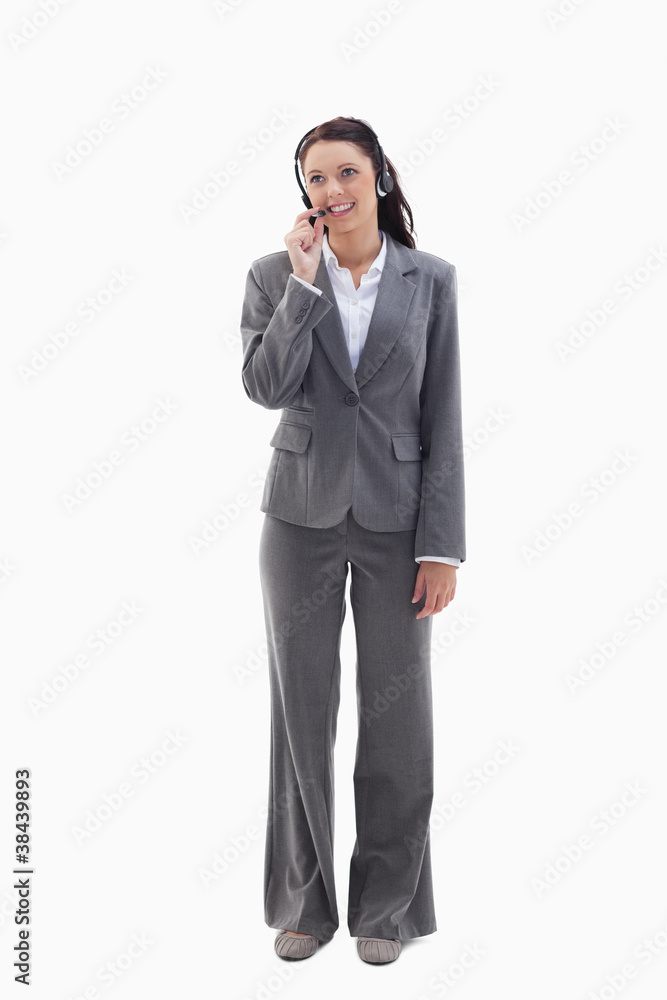 Businesswoman watching on the top speaking in a headset Businesswoman watching on the top speaking in a headset