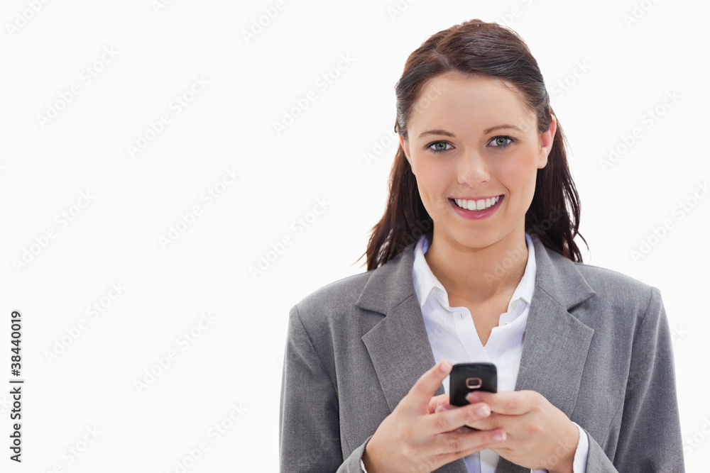 Businesswoman smiling and holding her mobile Businesswoman smiling and holding her mobile