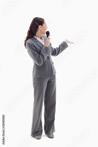 Businesswoman announcer speaking in a microphone photo