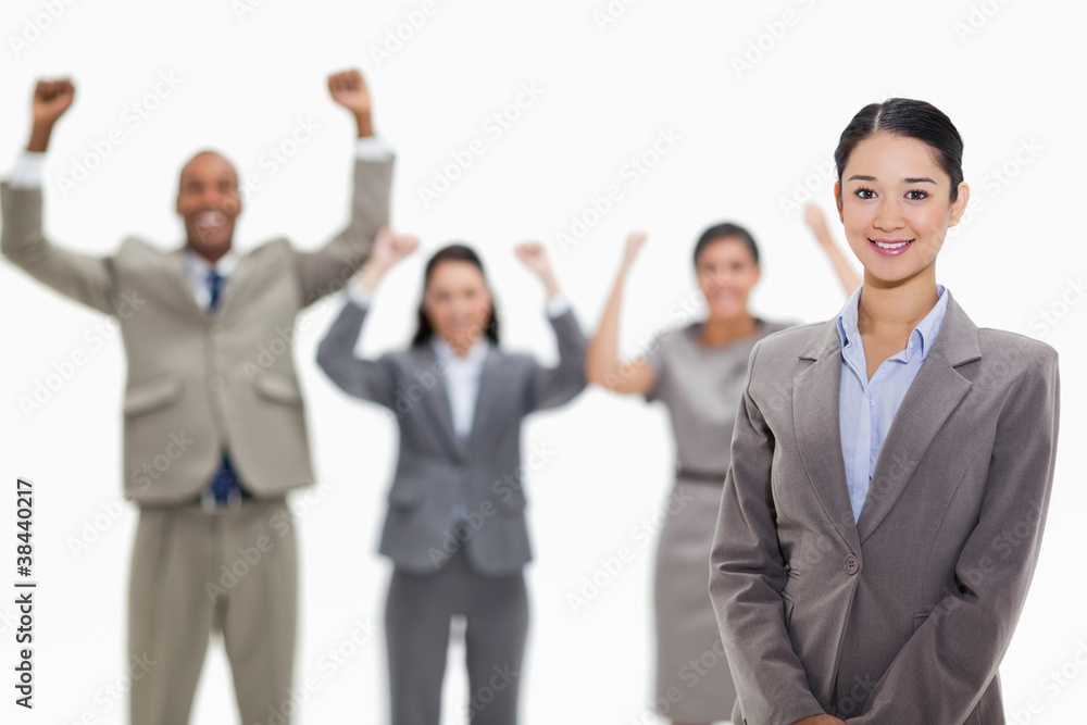 Businesswoman smiling with enthusiastic co-workers Businesswoman smiling with enthusiastic co-workers
