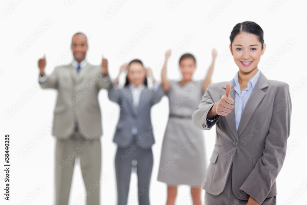 Approving business team with thumbs-up Approving business team with thumbs-up