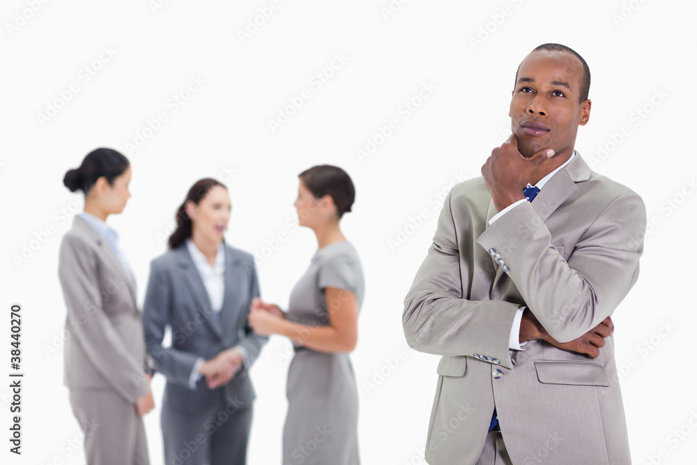 Thoughtful businessman looking up with co-workers Thoughtful businessman looking up with co-workers