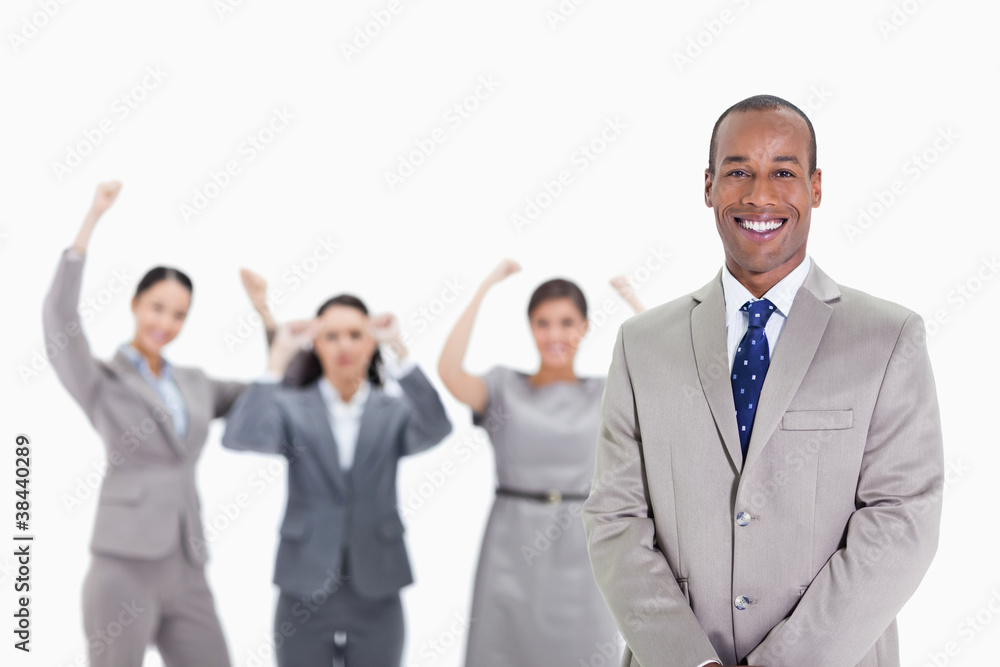 Happy businessman with enthusiastic co-workers in the background Happy businessman with enthusiastic co-workers in the background