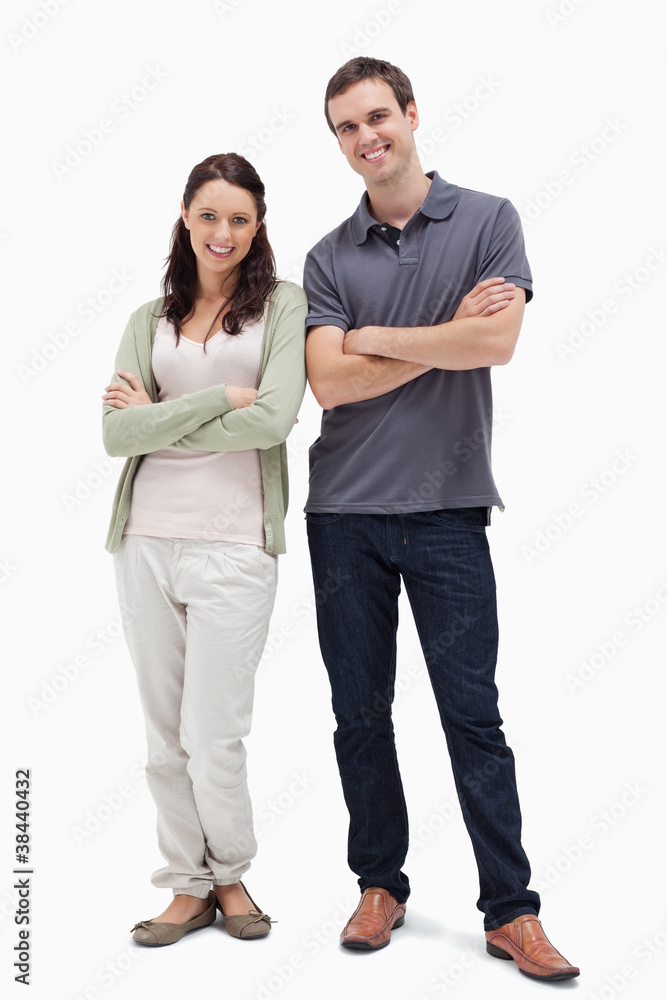 Smiling couple crossing their arms Smiling couple crossing their arms