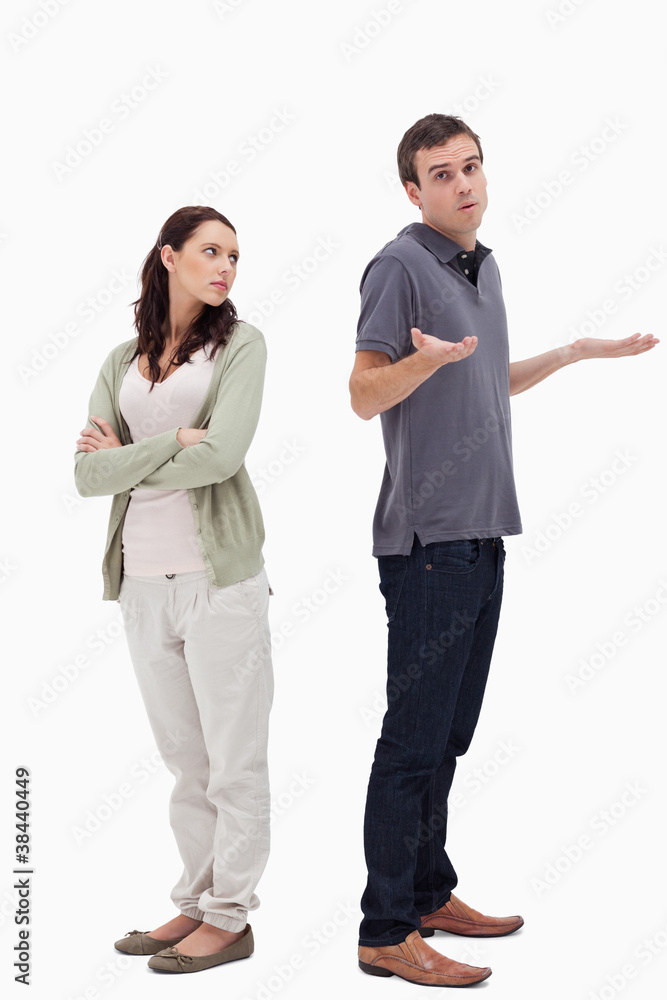 Man shrugged his shoulders back to back with angry woman Man shrugged his shoulders back to back with angry woman