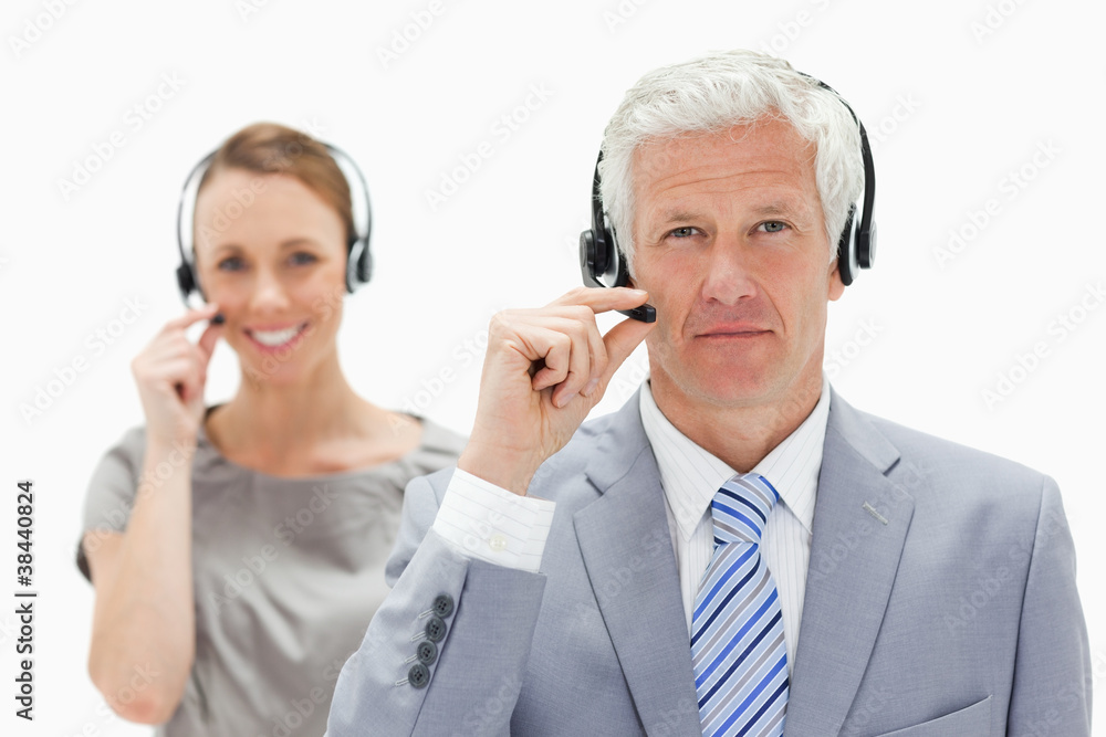 Close-up of a white hair man with a smiling woman in background Close-up of a white hair man with a smiling woman in background